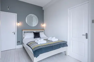 a bedroom with a bed with two towels on it at The Apartment at Clare House, Aldeburgh in Aldeburgh