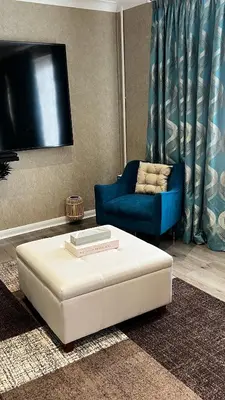 a living room with a couch and a tv at Cheerful 3 bedroom Townhouse with free parking. in Billericay