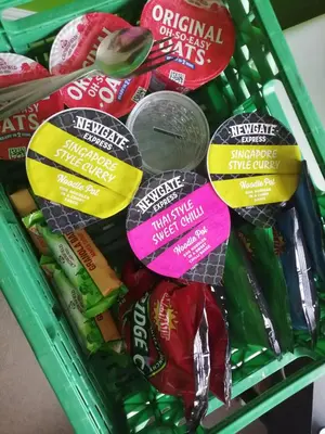 a basket filled with different types of chips and candy at 59 Halstead - Gorgeous single bedroom with private bathroom in Halstead