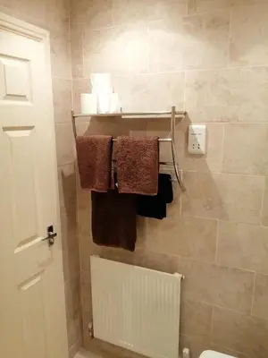 a bathroom with towels hanging on a wall at 59 Halstead - Gorgeous single bedroom with private bathroom in Halstead