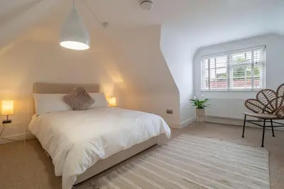 a bedroom with a white bed and a window at Crown Street in Bury Saint Edmunds