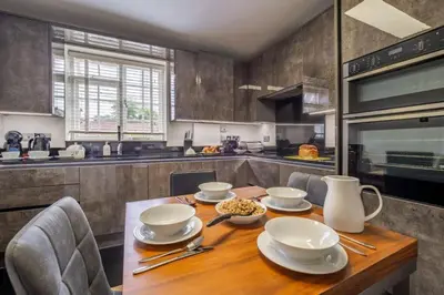 a kitchen with a wooden table with dishes on it at Crown Street in Bury Saint Edmunds
