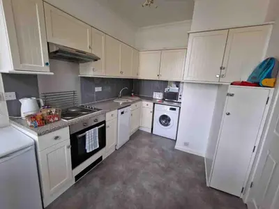 a kitchen with white cabinets and white appliances at Two Bedroom Mansion House Apartment By AZ Luxury Stays Newmarket With Parking And WiFi in Newmarket