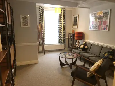 a living room with a couch and a table at Arts House in Harwich