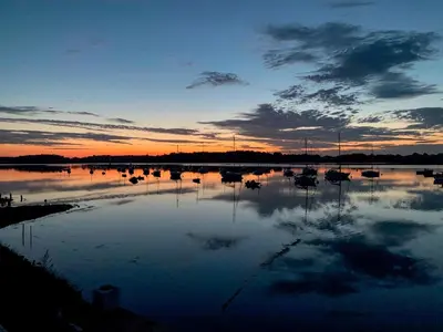 a large body of water with boats in it at sunset at Quayside Cottage Uk33899 in Waldringfield