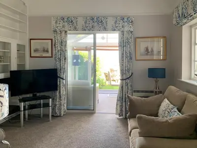 a living room with a couch and a television at Quayside Cottage Uk33899 in Waldringfield