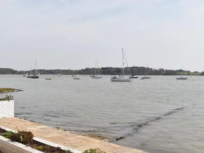 a group of boats in a large body of water at Quayside Cottage Uk33899 in Waldringfield