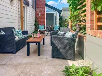 a patio with wicker chairs and a table at The Boathouse Uk33900 in Waldringfield