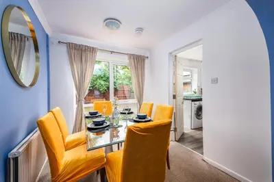 a dining room with a glass table and yellow chairs at Summer Deal 20 PRC OFF 4BR 2BATH Families Groups By Trinity Stays Short Lets & Serviced Accommodation Cambridge in Cambridge