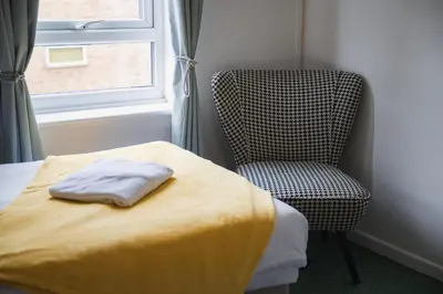 a bedroom with a bed and a chair and a window at Summer Deal 20 PRC OFF 4BR 2BATH Families Groups By Trinity Stays Short Lets & Serviced Accommodation Cambridge in Cambridge