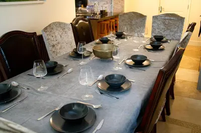 a long table with plates and wine glasses on it at Deluxe 4 or 5 Bed House with Hot Tub, Cinema Room Sleeps 15 in Saffron Walden