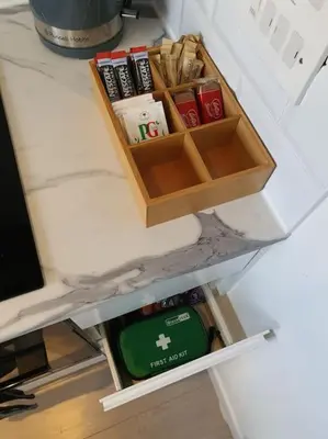 a drawer in a desk with a box on it at The Tiny Sea Gem in Jaywick Sands