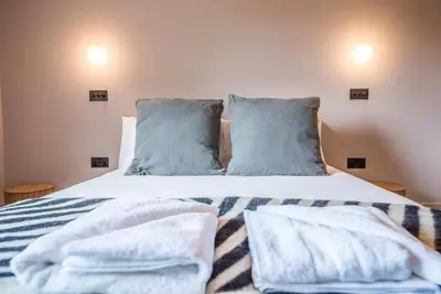 a bedroom with a bed with towels on it at The Limes, Benhall in Saxmundham