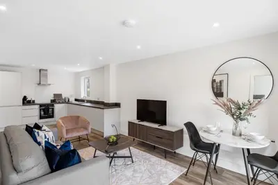 a living room with a couch and a table at Tailored Stays - Water Street Apartments in Cambridge