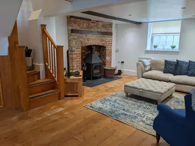 a living room with a couch and a fireplace at Beautiful Georgian townhouse in central Colchester in Colchester