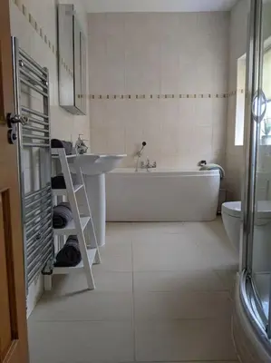 a bathroom with a tub and a sink and a toilet at Beautiful Georgian townhouse in central Colchester in Colchester