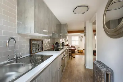 a kitchen with a sink and a counter top at Georgina in Lavenham