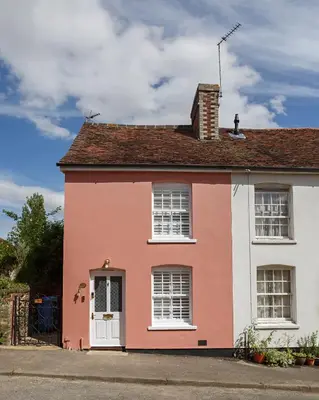 a pink and white house on a street at Georgina in Lavenham