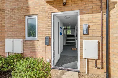 an open door of a brick building with a stairway at Modern Apartment in Wymondham in Wymondham