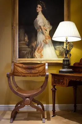 a painting of a woman next to a table with a lamp at The Crown, Bildeston in Bildeston