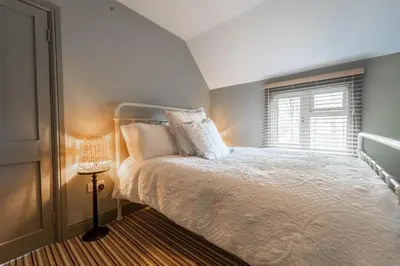 a bedroom with a white bed and a window at Suitable For Contractors 2 Double Beds and Sofa Bed Private Parking in Harlow