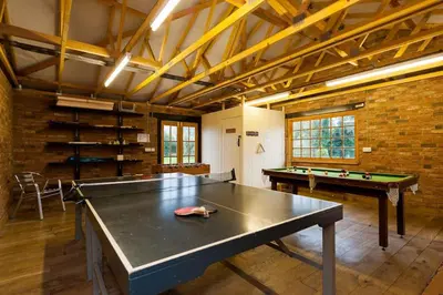 a large room with a ping pong table in it at The Old Mill, 7 storey,, dog friendly outdoor pool & bbq in Stoke Ferry