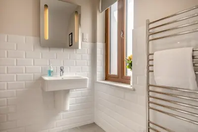 a white bathroom with a sink and a window at 3 Bed in Aldeburgh oc-16afaw in Aldeburgh