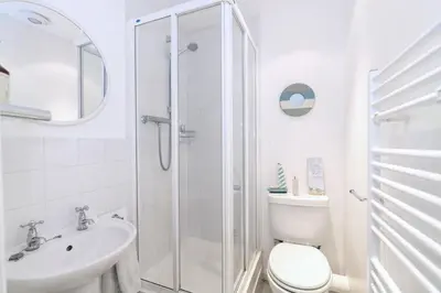 a bathroom with a shower and a toilet and a sink at The Bolthole in Aldeburgh