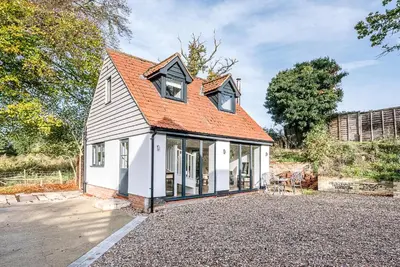 a small white house with an orange roof at Little Honey Pot, Benhall in Saxmundham