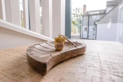 a small key sitting on top of a piece of wood at Little Honey Pot, Benhall in Saxmundham