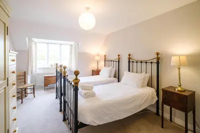 a bedroom with two beds with white sheets at 9 Whinlands in Thorpeness