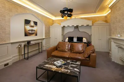 a living room with a couch and a bed at Talbooth House & Spa in Dedham