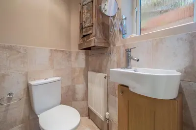 a bathroom with a toilet and a sink at The Pines in Aldeburgh