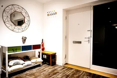 a bedroom with a bed and a mirror on the wall at Exquisite cozy house, close to Train Station and amenities in Harold Wood