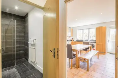 a kitchen and dining room with a table and a glass door at Charming & Spacious House With FREE PARKING in Chesterton
