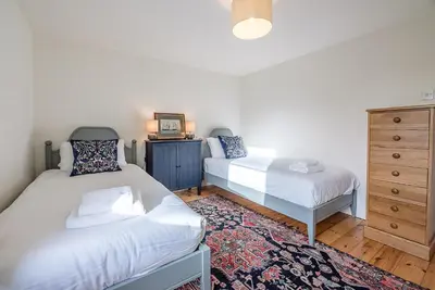a bedroom with two beds and a dresser at Solebay House, Tunstall in Woodbridge