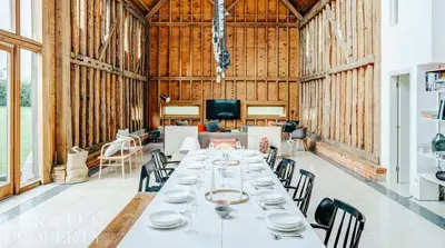 a large room with a long table and chairs at Grand Suffolk Barn Conversion in Chelsworth