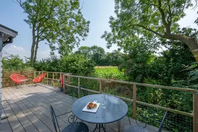a patio with a table and chairs and a field at 2 Bed in Stradbroke oc-wopl in Stradbroke