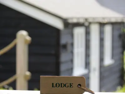 a sign that reads lodge in front of a house at 9 Uplands in Thorpeness