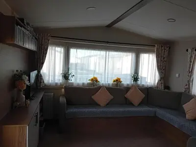 a living room with a couch in front of a window at Caravan in Jaywick,Jaywick sand, Clacton-on-sea in Jaywick Sands