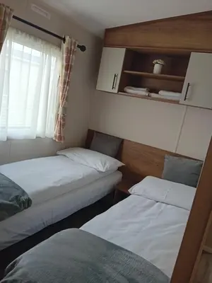 two beds in a small room with a window at Caravan in Jaywick,Jaywick sand, Clacton-on-sea in Jaywick Sands