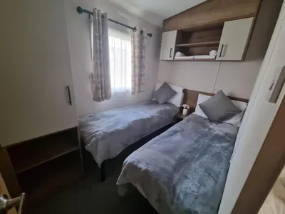 two beds in a small room with a window at Caravan in Jaywick,Jaywick sand, Clacton-on-sea in Jaywick Sands