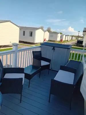 a patio with chairs and tables on a deck at Caravan in Jaywick,Jaywick sand, Clacton-on-sea in Jaywick Sands