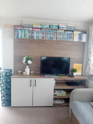 a living room with a tv and a white cabinet at Caravan in Jaywick,Jaywick sand, Clacton-on-sea in Jaywick Sands