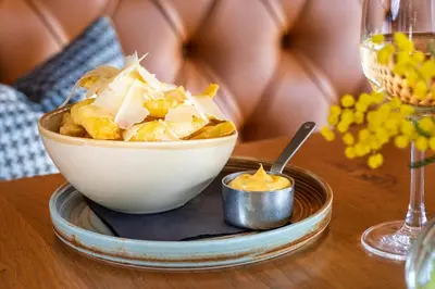 a bowl of potato chips on a table at The Weeping Willow in Bury Saint Edmunds