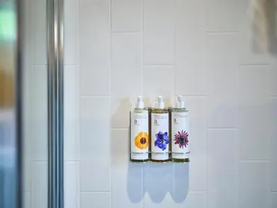 three candles are on a shelf in a bathroom at The Weeping Willow in Bury Saint Edmunds
