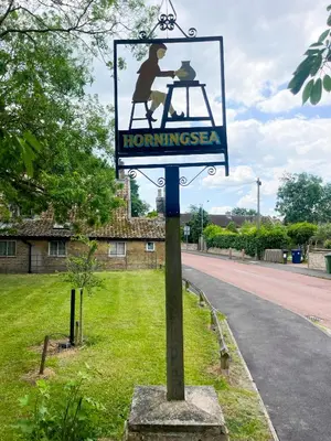 a sign on a pole on the side of a road at Cosy Courtyard Cottage sleeps 4 with Log Burner, close to Cambridge in Cambridge