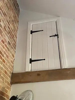 a window with three iron bars on it at Lynford Holiday Cottages nestled in the heart of Thetford Forest in Mundford