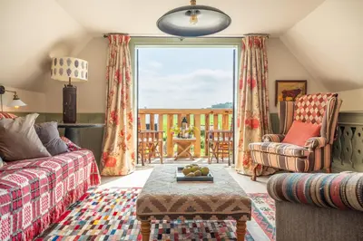a living room with a couch and a table at Vibrant rural hideaway - Aspen Loft in Sudbury