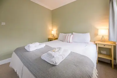 a bedroom with a bed with towels on it at Pelican Cottage, Aldeburgh in Aldeburgh